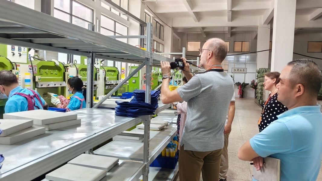 Datong Vietnam team and international partners reviewing insole samples during a factory visit.